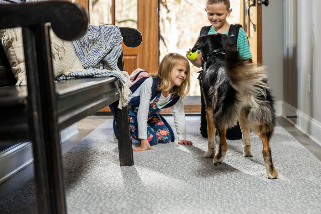 Kids plying with dog on carpet flooring | Shelley Carpets
